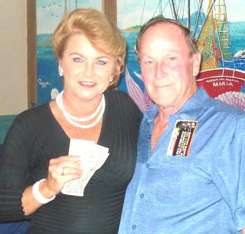 Judy collects the raffle money from Richard at Rock Barn Golf & Spa on September 10-16, 2007. Hickory ASGA members, who worked as volunteers, were Ann B.