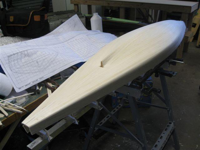 I then positioned a parallel 10 mm full length plank on each side of the hull near the tumble home curve and proceeded to plank the remainder of the hull bottom.