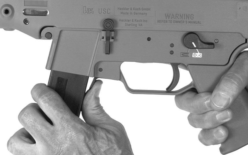 With your thumb, push cartridges forward out of the magazine into the palm of the other hand OR Grasp magazine and hold it with the points of the bullets pointing towards the bottom.