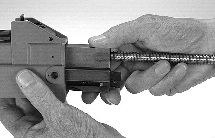 5. Pull back the cocking lever and remove the recoil spring assembly and the bolt to the rear (figure 25). Fig. 25 Removing recoil spring Disassembly of the Bolt 1.