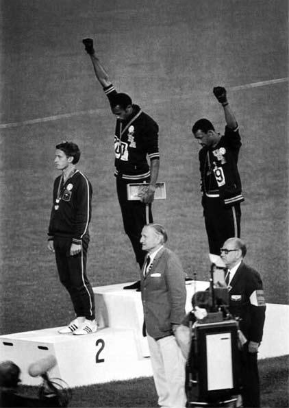 Why is he considered a household name throughout the United States even today? And why do the other medallists Tommie Smith and John Carlos consider him a brother?