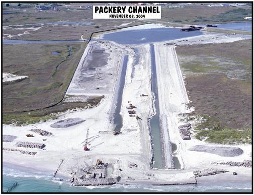 is a channel through the barrier island that allows water driven by the tides to enter the bay at high tide and leave the bay at low tide. Figure 2. Construction at Packery Channel, November 8, 2004.
