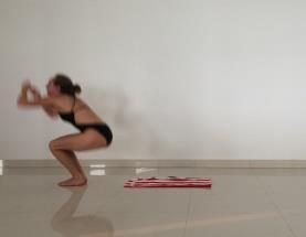 The back of the shoulders reach the floor as the body rolls forward while holding the knees with the hands. The feet press into the ground at the end of the rotation to stand up.