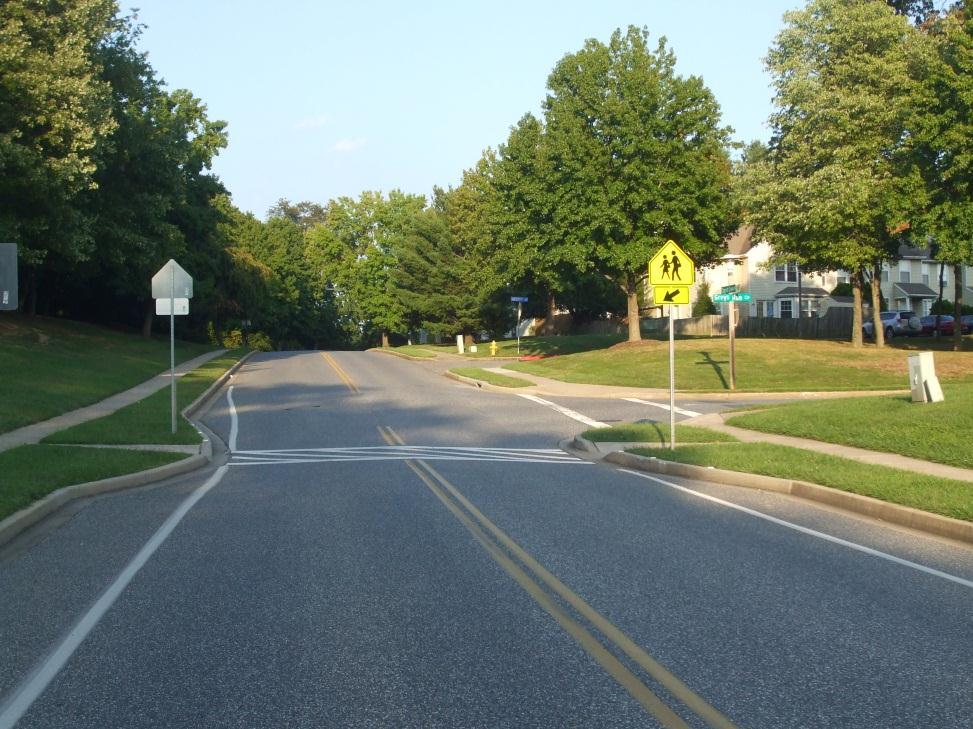 traffic calming to reduce vehicle speed and reduce student crossing time.