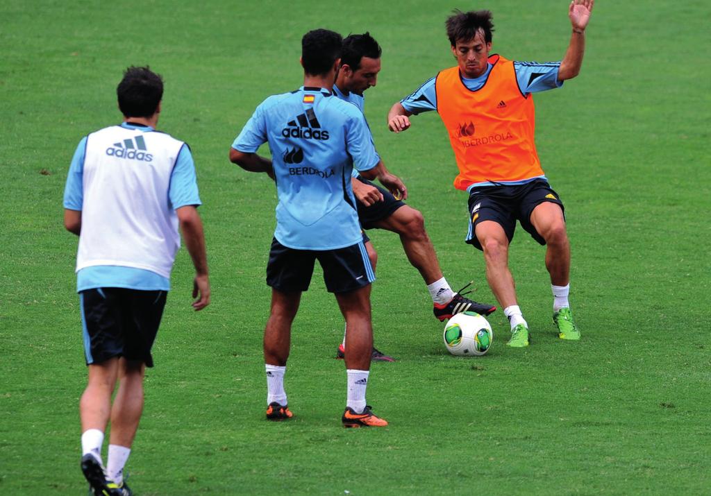 OVERLOAD DECISIONS David Silva (R) fights for the ball with team mate Santi Cazorla (2nd R) during a rondo training session with the Spain national squad Making Overload Decisions Players with the