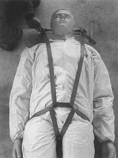 426 Rescue Figure 18.10 Harnesses worn by victims or improvised harnesses rigged to them can be used to prevent the patient from sliding downward in a vertically oriented package.