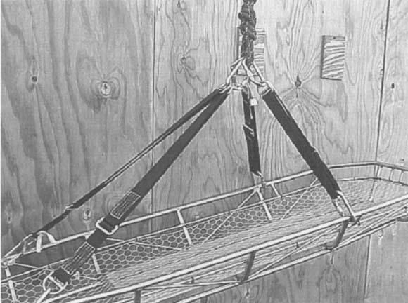 The swivel prevents twisting of the lowering line as the litter is lowered down the stairwell, as described later in this chapter.