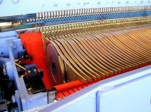 The yarn on the spool forms the Weft.