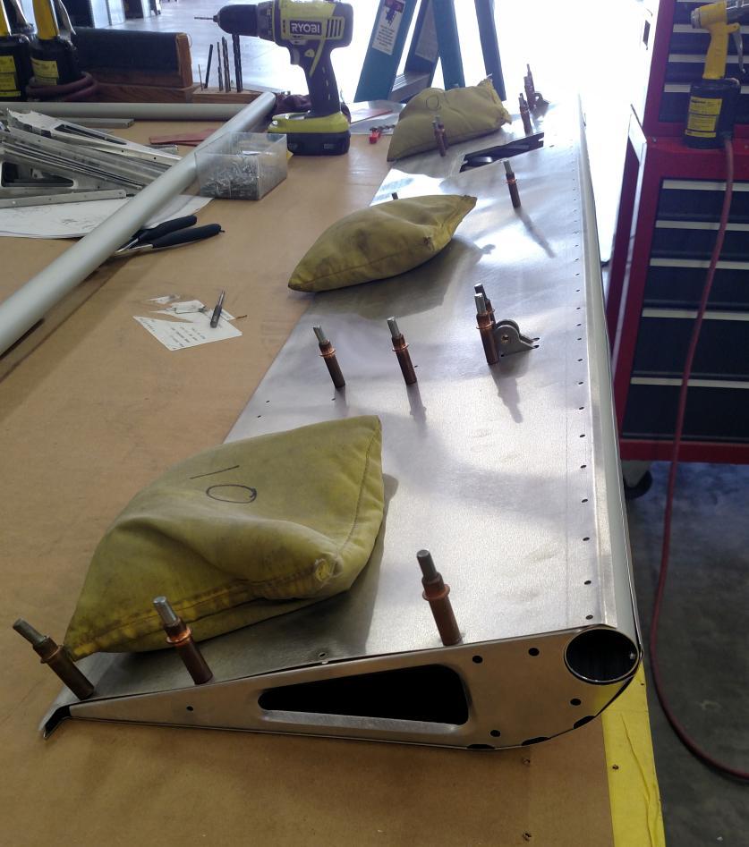 Balancing the ailerons requires them to be pinned to the hinges on the wing, then pulling down with a fish