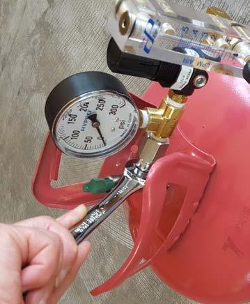 Use a 9/16 inch wrench to secure the flow system to the helium