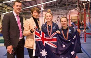 Mayor of Warringah, Mr Michael Regan and Mrs Margie Abbott present an Australian flag to Australian tumbling champions Tahnee Wickham and Darcy Ridhalgh. Gold Level $5,000p.a. 3-year in-house sponsor signage (3.