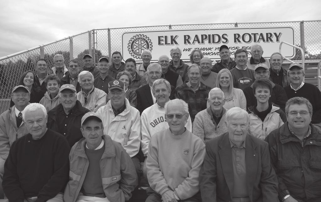 Rotarians in the stands at the new Elk Rapids football stadium addition, quite some years ago, the club started a college scholarship program.