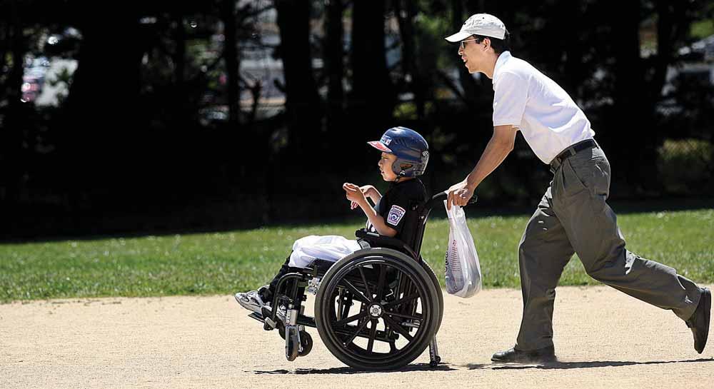 Bai Wang pushes his son, 11-year-old Dawei Wang, down the base line. Challenger Baseball (continued from page 35) That s what it s about, dude! Justin enthused, high-fiving his friend.