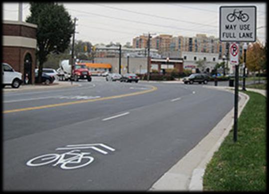 Sharrows are designated with a bicycle symbol and two chevron stripes. Additional signs permitting bicyclists to use the full travel lane are typically also installed.