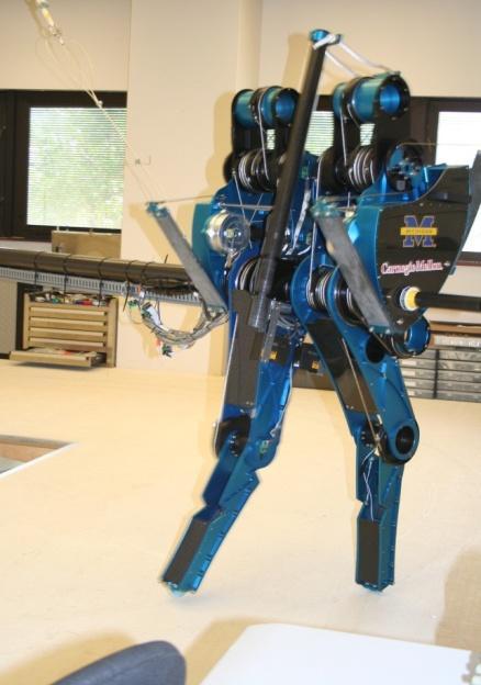 3. INTRODUCTION MABEL is a planar bipedal robot, as shown below. She is composed of five links that form a torso and two legs with knees.