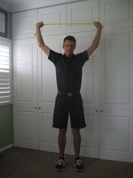 Squat with Pull Down Holding theraband above their head, the golfer pulls