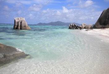 A large dramatic granite boulders and massifs with hard coral formations dropping to sand at 28-30 meters.