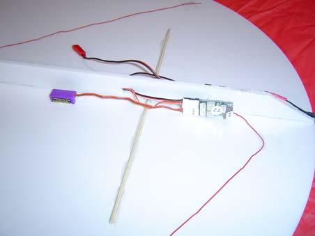 Connect the servos to the proper channels, and route the antenna wire around the wing as shown in the pictures. Secure the antenna with tape.