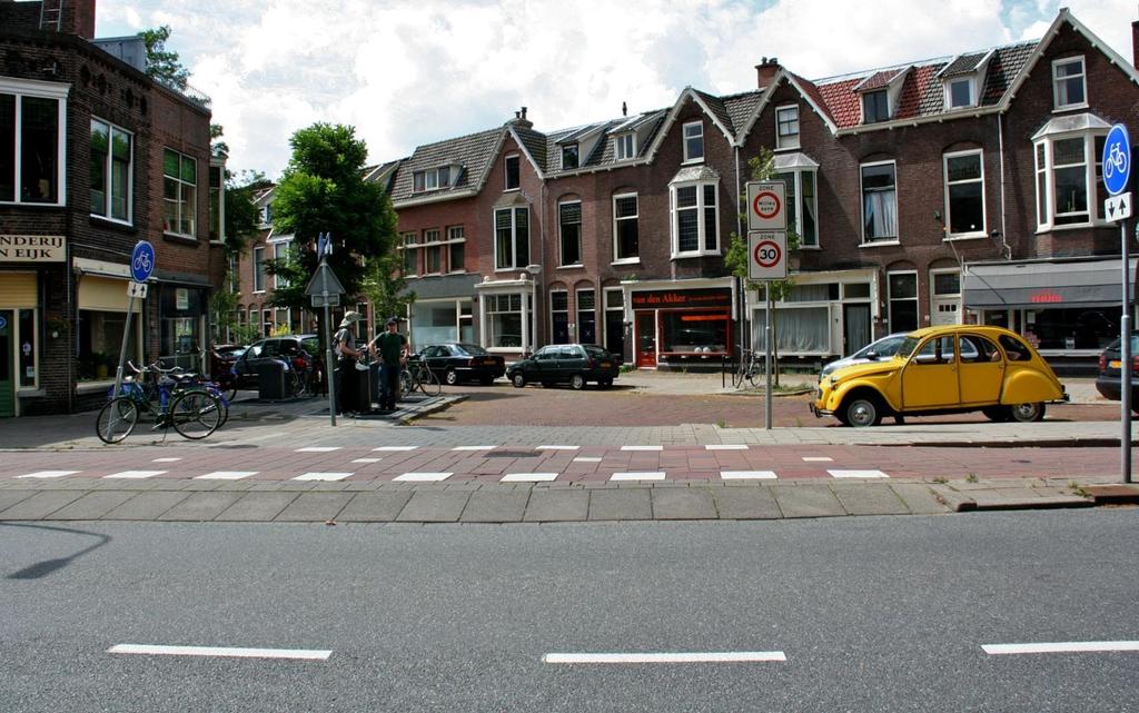 Raised crossing carries a two-way cycle track across a minor street at an intersection in Delft.