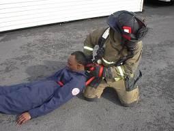 Upper compartments not threatened by fire. 4. Adjacent compartments not threatened by fire. 5. Below the fire area. Figure 22: Example of webbing girth hitch around victim s torso.