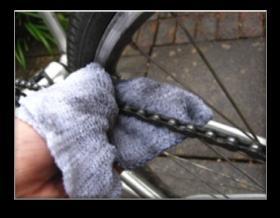 Use a wet brush to scrub the chain. Work your way into each chain link Run the chain through a damp cloth.