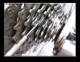 Use a brush to scrub the rear derailleur. Again use a screwdriver to get any stubborn dirt out.