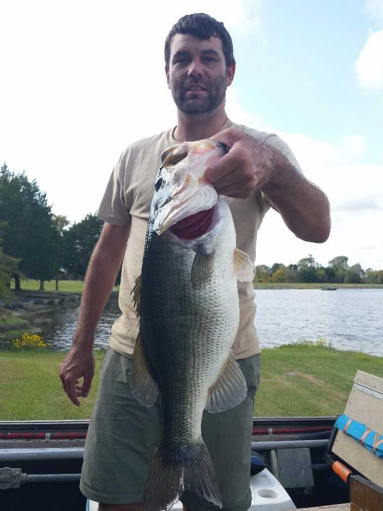 Chris McKee, District 3 Fisheries Biologist, poses with a nice 7-pound bass that he shocked up during his fall