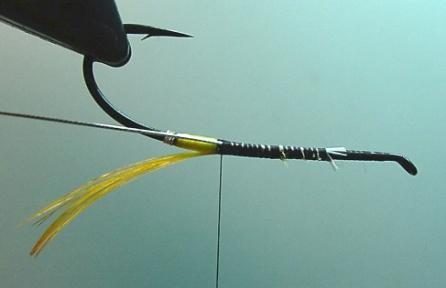 5. To minimize bumps in the body, tie-down the ribbing core along the bottom or slightly to the off-side of the bottom of the hook shank using flat thread turns.