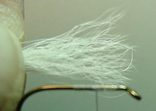 Select and clean a small bunch of calf tail hair fibers. Double stack the fibers to assure the tips are even. Measure the calf tail fibers for length (Fig. 3.