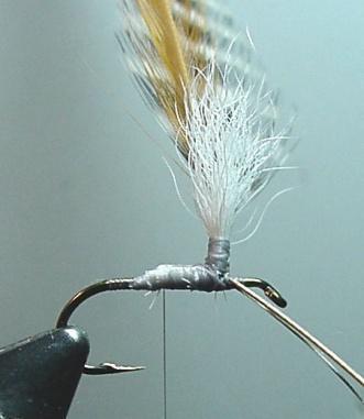 4. Select and prepare the hackles. Strip off webby hackle fibers to provide a clean stem for the tie-in zone on the stem. Attach the hackles in front of the wing post with the hackles to the far side.