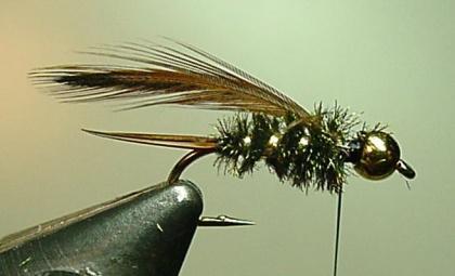Wrap the flat tinsel forward making 4 to 5 evenly spaced turns for size 10-14 flies.
