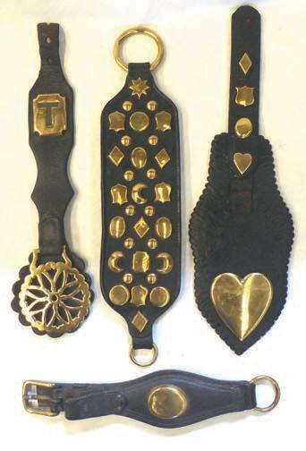 807 Six various swingers, two with plumes 778 Four leather straps - one decorated with various brass studs and a brass ring at each end; a hip drop with brass and a brass stud engraved T; a leather