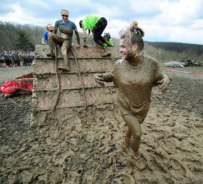 Racers climb a slippery wall as part of a mud run. Sticky mud makes everything harder in a mud run. They Don t Make It Easy Running through mud isn t easy.