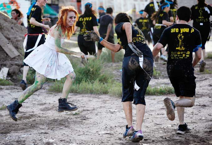 A woman dressed as a zombie chases racers during a zombie-themed mud run. Monsters in the Mud Some mud runs have themes, or flavors. Themes, such as zombies, add an extra twist to a run.