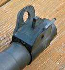 It has a rear sight with an aperture. The rear sight also has adjustments for windage and elevation.
