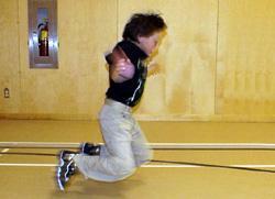 Movement: Using upper body momentum, thrust body forward to