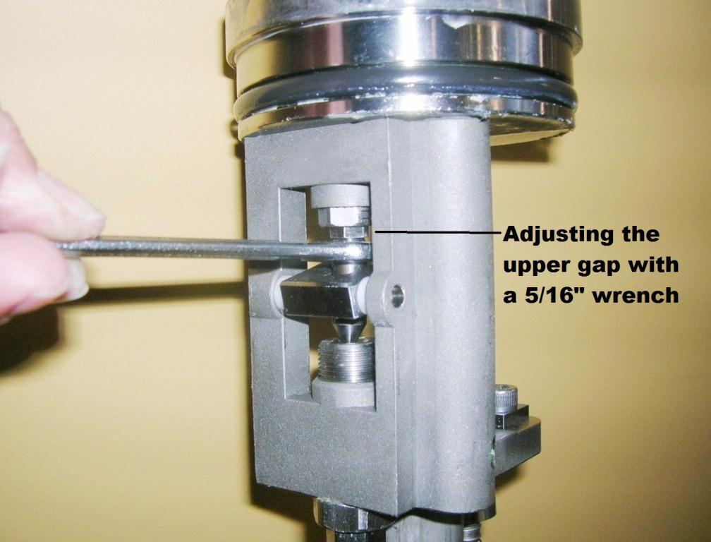 Using a 5/16 wrench, adjust the gap