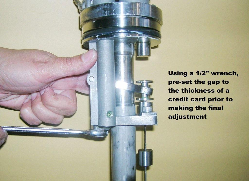 Figure 4-11 With the pump held vertically, raise the float to force the control rod to the up position (upper magplate being held by the
