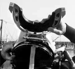 The tender must check to see that this is properly engaged. Grasp the base of the helmet with your fingers and push the neck dam/ring up into the neck ring on the base of the helmet.