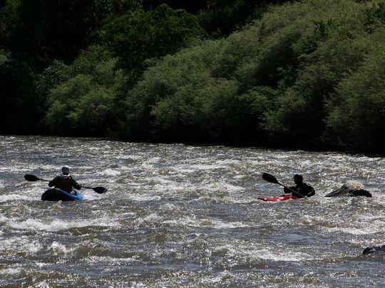 Buy Photo Paddlers Ben Spillman, left, and Noah Fraser navigate some class II rapids on the Truckee River in the Reno/Sparks area on May 13, 2016.