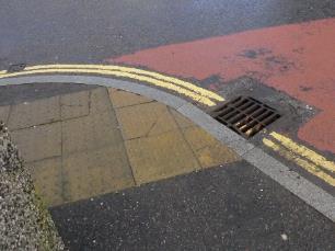 At the corner of Market Square crossing South Road towards Kirk Street, the dropped kerb is beside a drain, and on the Kirk Street side the footway is very narrow.