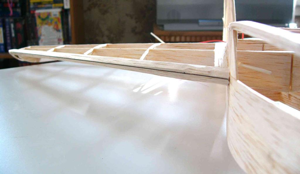 With 1mm balsa, fill in the area between the fuselage tops and the main ribs back to the second dihedral brace, and a triangle in front of the uprights at the leading edge for the covering to adhere