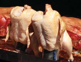 Discard giblets and neck from chicken; drain and pat dry with paper towels. Fit whole chicken over the can of beer with the legs on the bottom; keep upright. Brush the chicken with the vegetable oil.