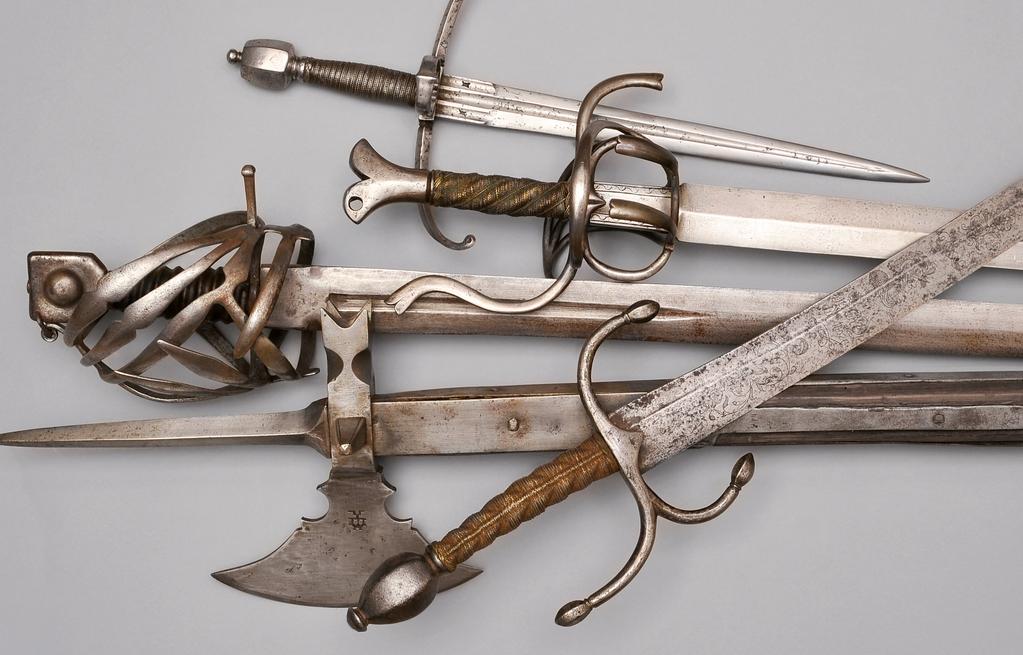 Main gauche, Italian, around 1580. Blade with ricasso and smith s marks, extra-wide iron crossguard with parrying ring, iron pommel. Rapier, Austrian, around 1600. Ambras type.