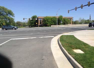 The wide turn radii also increase the crossing distance for pedestrians and cyclists attempting to cross Reston Station Dr.