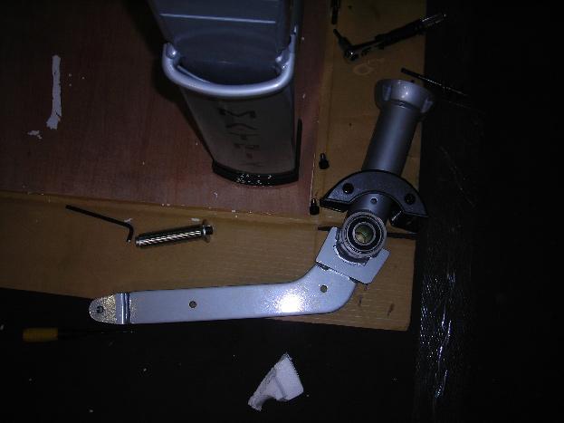 6) Remove the pivot shaft and rear pivot arm from the frame (Figure E).