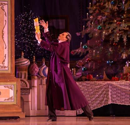 Dinner is served, and everyone except Marie, Karl, Drosselmeyer and Clara exit toward the dining room. Drosselmeyer gives Clara her special present the magic Nutcracker doll.