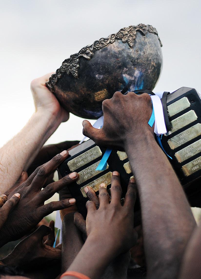 Explore I TIWI ISLANDS Festival of footy Off the coast of Darwin, the Tiwi Islands Football League reaches a colourful crescendo at the Grand Final The Muluwurri Magpies raise the premiership cup.