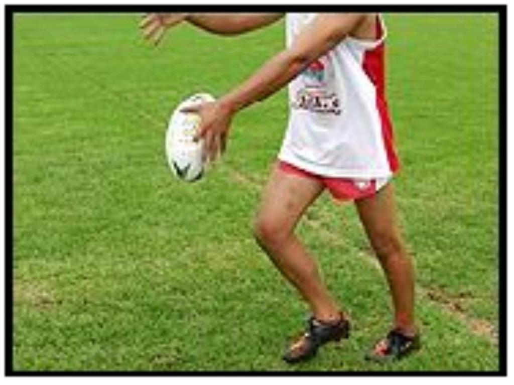 - The ball is guided down with the hand on the kicking side.