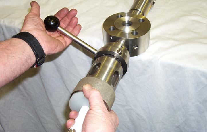 As the cam engages the sample device automatically opens the valve in the sampling body, a representative sample flows from the pipeline into the borosilicate glass cylinder under pressure from